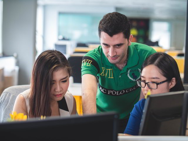 What Are The Best Educational Technology Tools? 1 educational technology - teacher pointing at screen with two asian girls